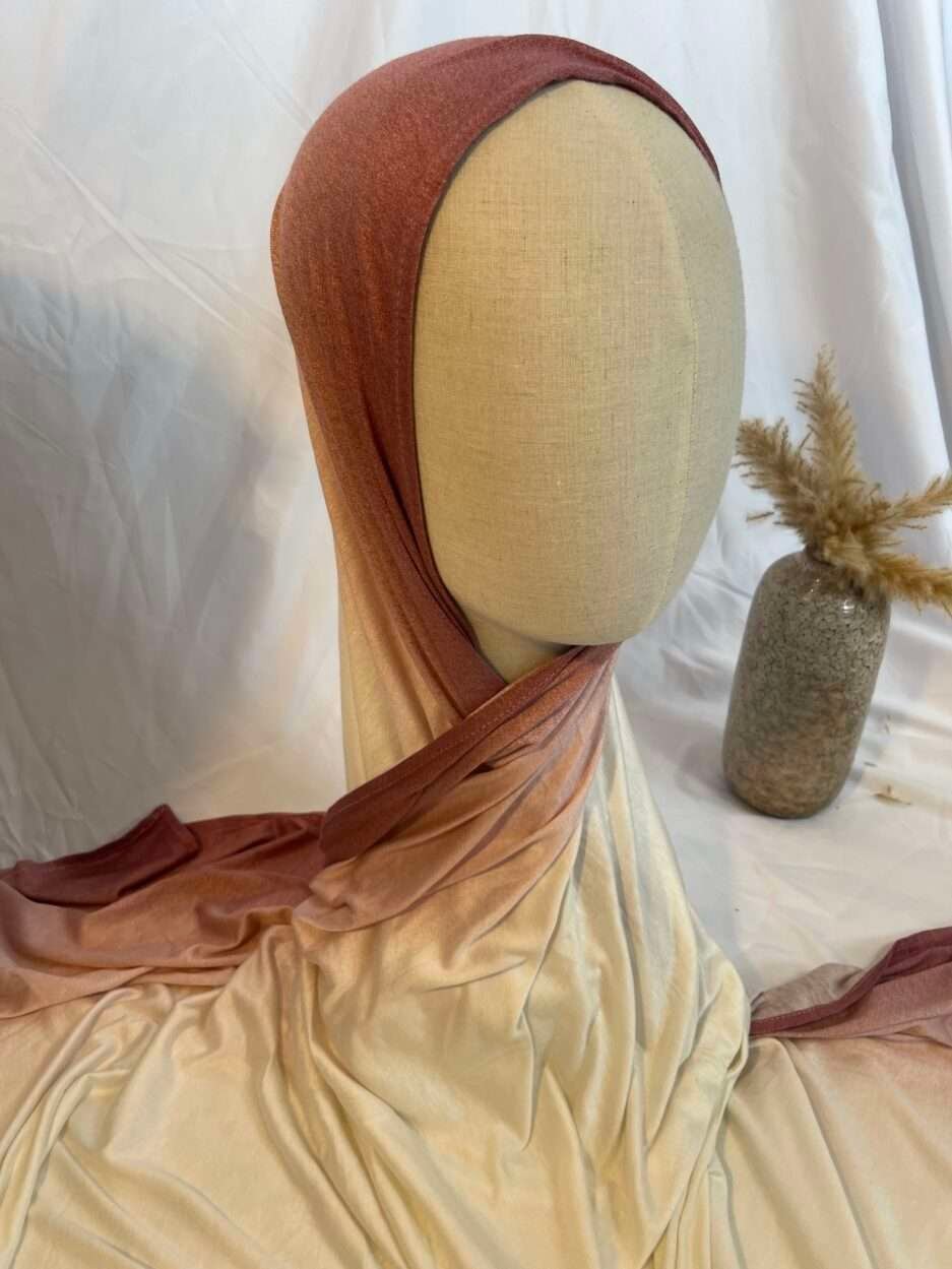 Hijab en jersey lycra avec un dégradé de couleurs allant du vieux rose au crème, présenté sur un mannequin.