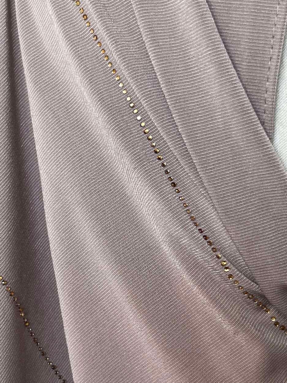 Hijab taupe rosé en jersey doux avec de fines lignes de strass dorés scintillants, présenté sur un mannequin.
