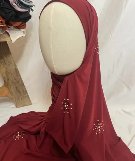 Hijab rouge bordeaux uni en jersey doux, orn&eacute; de broches effet rubis (perles et strass rouges), pr&eacute;sent&eacute; sur un mannequin.